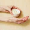 Burn & Bliss Soy Wax Massage Oil Candle - Soothing Lotus in hand